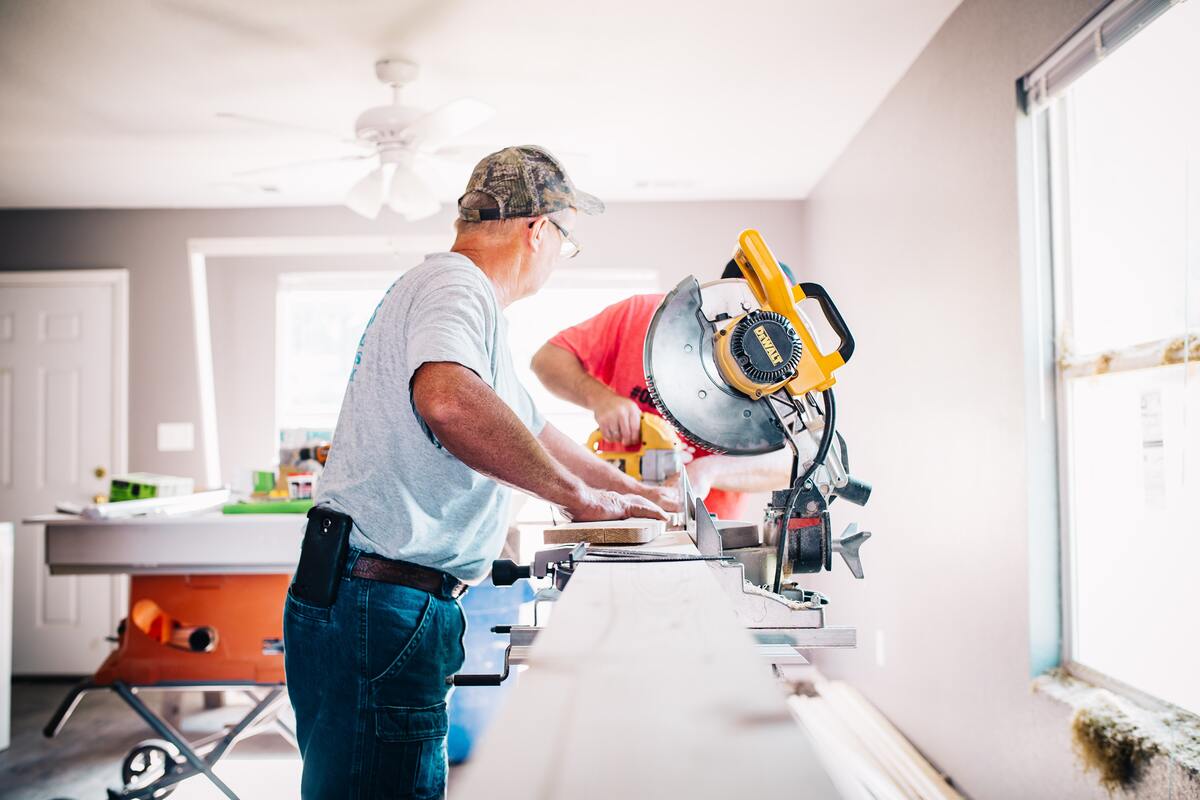 Carpenter cutting wood with a saw