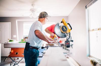 Carpenter cutting wood with a saw